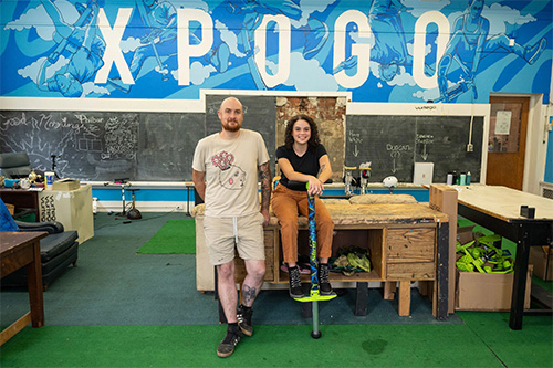 CMU student Zoe Brown talks with Xpogo CEO Will Weiner while editing video at Xpogo, as part of Dietrich College’s 2024 Pittsburgh Summer Internship Program.