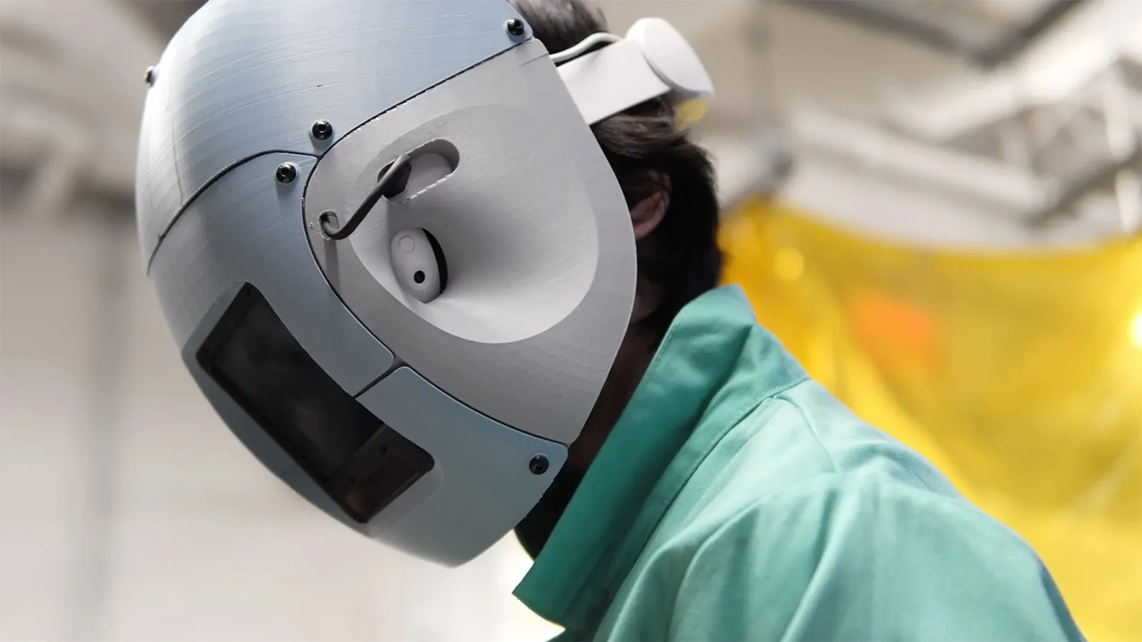 Welder wearing a mixed reality welding helmet.