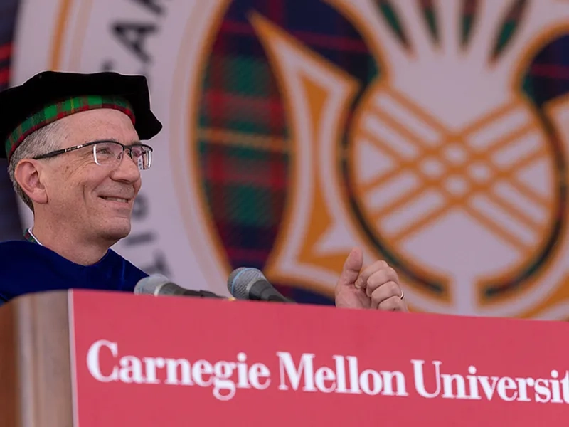 Provost Jim Garrett smiling at a podium