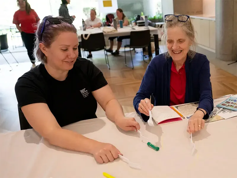 Teacher summer camp participants engaged in a design activity.