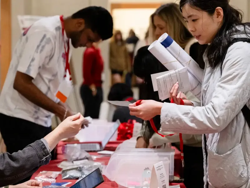 Students vising tables at energy week